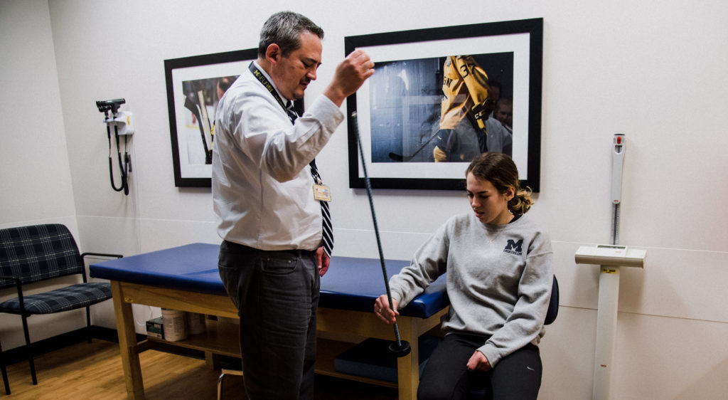 Doctor testing patient reflexes